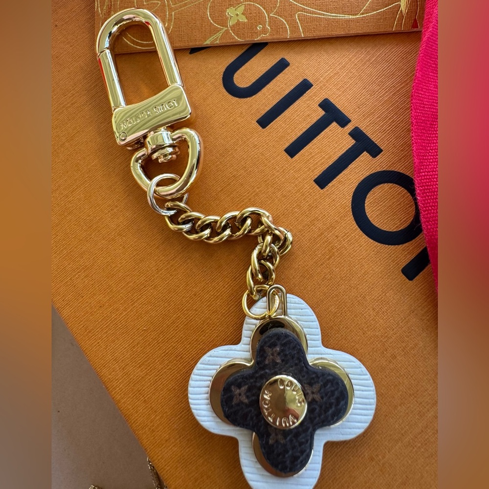 Lv luxury flower key chain or bag charm. Brown cream and hold hardware.